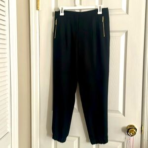 Black dress pants.  Flat front, loose leg,  gathered bottom.  Zipper detail
